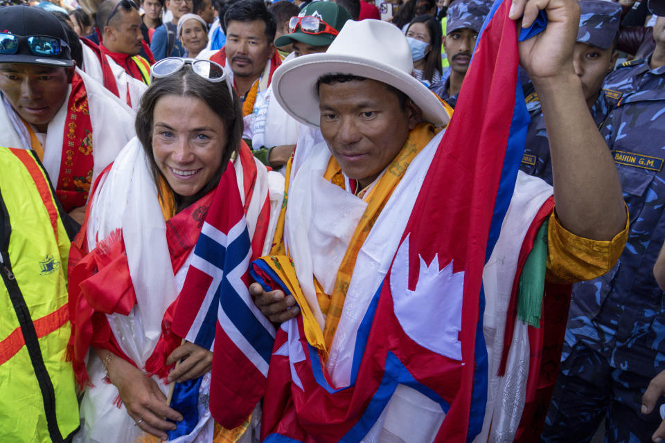 Norwegian climber Kristin Harila, left, and her Nepali sherpa guide Tenjen Sherpa, right, who climbed the world's 14 tallest mountains in record time, arrive in Kathmandu, Nepal, Saturday, Aug. 5, 2023. Harila and Sherpa shattered the record for the fastest climb of the 14 mountains more than 8,000 meters (about 26,000 feet) high when they topped Mount K2 in Pakistan late last month. The previous record was 189 days, and the pair did it in 92 days. (AP Photo/Niranjan Shrestha)