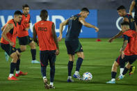 Portugal's Cristiano Ronaldo, center, plays the ball with teammates during his team training session at the World Cup in Doha, Qatar, Thursday, Dec. 8, 2022. (AP Photo/Francisco Seco)