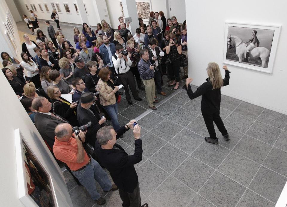 Annie Leibovitz talks about some of her work during a tour of her exhibition at the Wexner Center for the Arts Friday, Sept. 21, 2012, in Columbus, Ohio. Leibovitz's exhibition features work from her “Master Set,” an authoritative edition of 156 images. (AP Photo/Jay LaPrete)