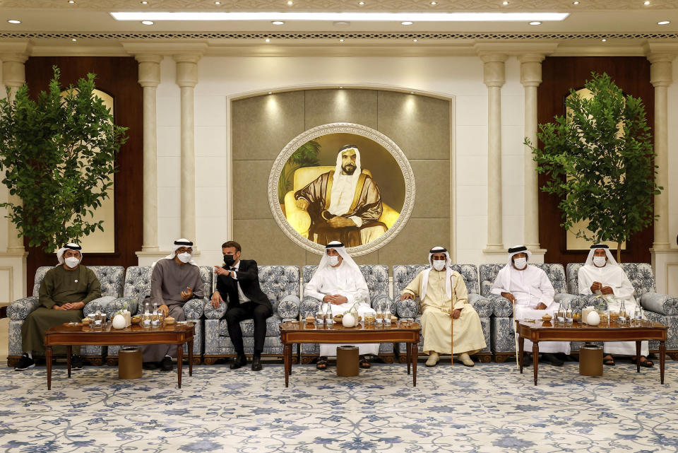 Newly-elected president of the United Arab Emirates Sheikh Mohammed bin Zayed Al Nahyan, 2nd left, meets French President Emmanuel Macron, 3rd left, to mourn the death of Sheikh Khalifa Bin Zayed Al Nahyan at Al Mushrif Palace in Abu Dhabi, United Arab Emirates, Sunday, May 15, 2022. (Christian Hartmann, Pool via AP)