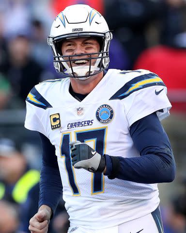 <p>Rob Carr/Getty</p> Philip Rivers #17 of the Los Angeles Chargers smiling in uniform