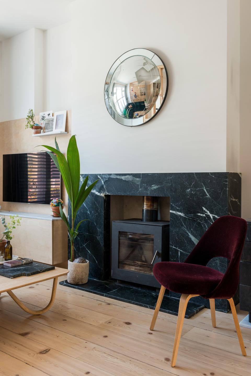 Also found in the one-bedroom on Epirus Road is a simple but so luxe hearth and an awesome plywood TV unit.