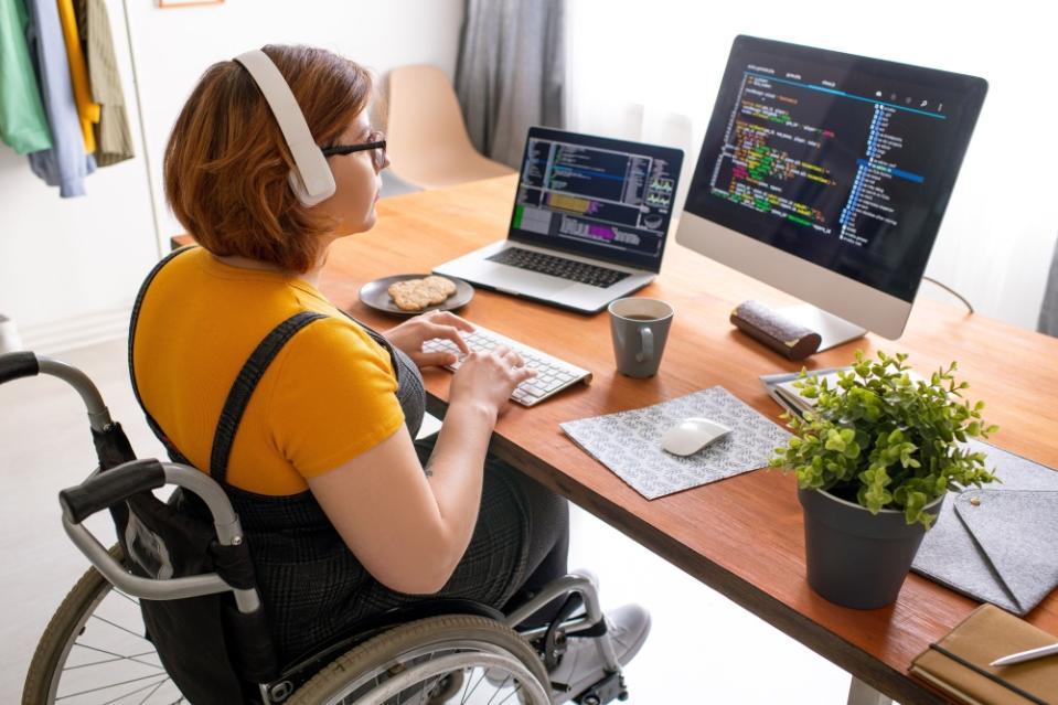 A disabled person is seen working on her computer. ― ETX Studio pic