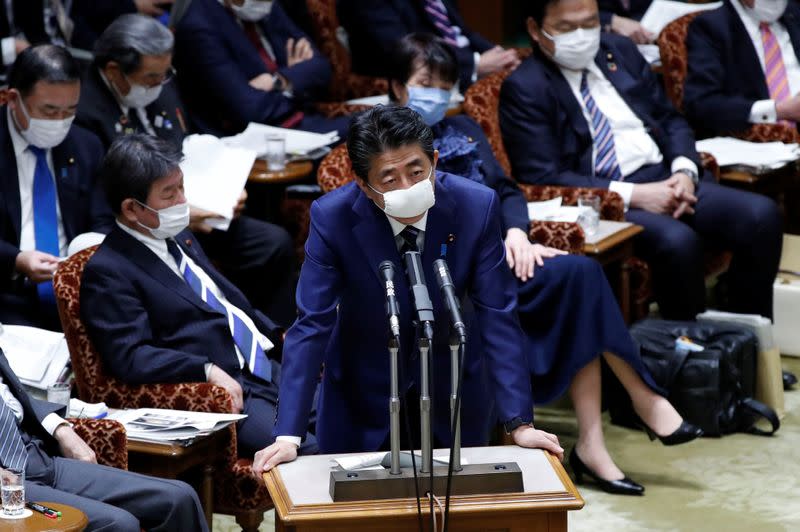 Japan's Prime Minister Shinzo Abe wears a protective face mask as he attends an upper house parliamentary session