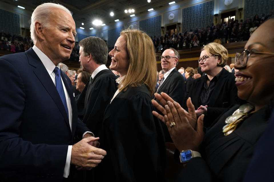 President Joe Biden greets Supreme Court Justice Amy Coney Barrett as Justice Ketanji Brown Jackson applauds as he arrives to give the State of the Union address to a joint session of Congress at the Capitol, Tuesday, March 1, 2023, in Washington. (Jacquelyn Martin, Pool)