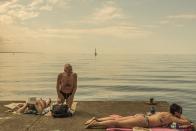 <p>Different generations lounge on a pier on holiday. (Andrea Rossato/SWPA) </p>