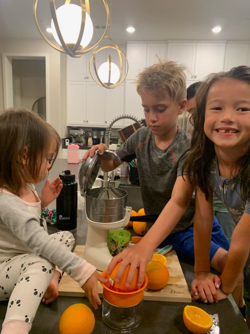 Kids playing with manual juicer