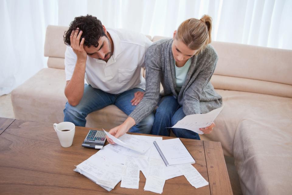 Depressed couple doing their accounting in their living room