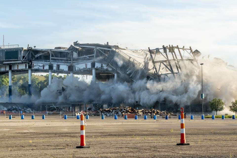 The Palace of Auburn Hills undergoes a controlled demolition in Auburn Hills, Mich., on Saturday, July 11, 2020. Opened in 1988, the multi-use stadium was the home of the Detroit Pistons as well as numerous concerts and sporting events. (David Guralnick/Detroit News via AP)