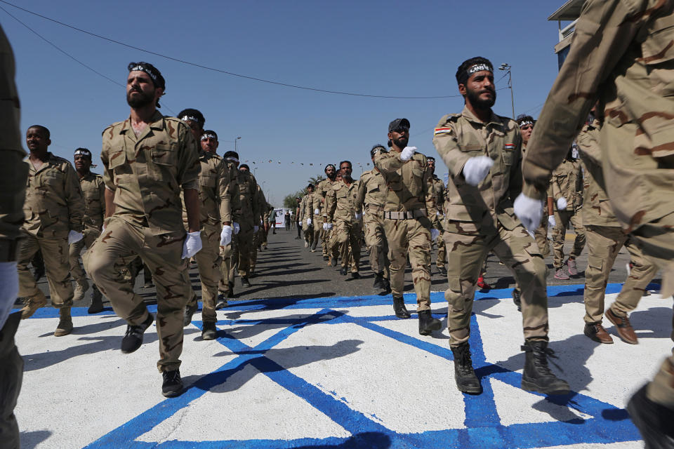 Iraqi Popular Mobilization Forces march over a representation of an Israeli flag during "al-Quds" Day, Arabic for Jerusalem, in Baghdad, Iraq, Friday, May 31, 2019. Jerusalem Day began after the 1979 Islamic Revolution in Iran, when the Ayatollah Khomeini declared the last Friday of the Muslim holy month of Ramadan a day to demonstrate the importance of Jerusalem to Muslims. (AP Photo/Khalid Mohammed)