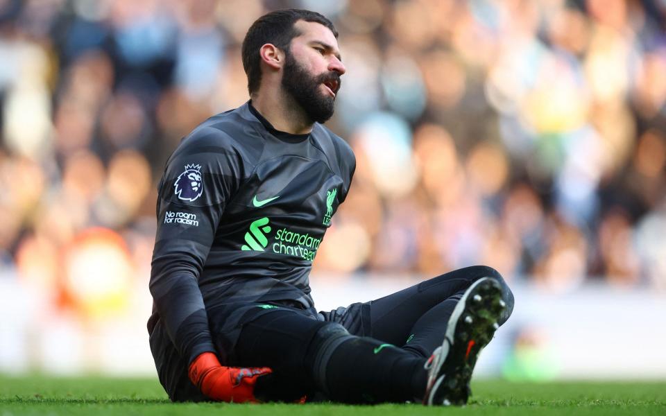 Liverpool's Alisson reacts after sustaining an injury