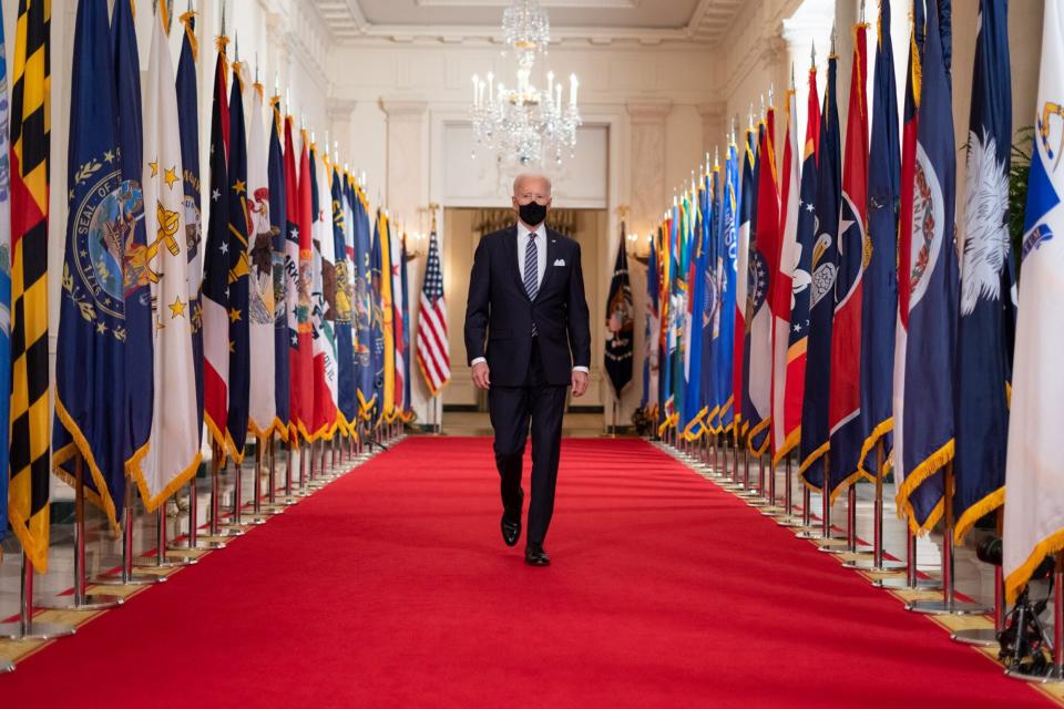 President Joe Biden walks from the State Dining Room of the White House to a podium in the Cross Hall of the White House Thursday, March 11, 2021, to deliver remarks on the one year anniversary of the COVID-19 Shutdown.