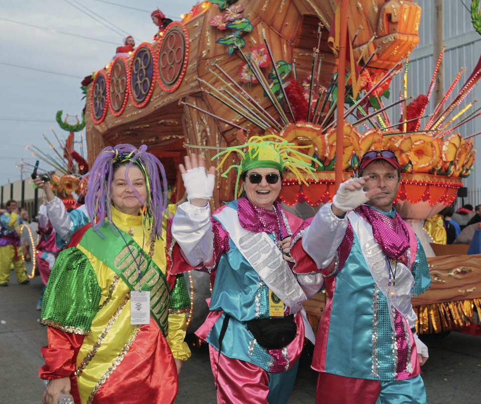 Riders in the Mardi Gras parade make their way to their float in the staging area of the parade in New Orleans, Monday, Feb. 20, 2012. (AP Photo/Bill Haber)