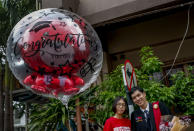 A university student poses for a photo ahead of his graduation ceremony at the Thammasat University in Bangkok, Thailand, Friday, Oct. 30, 2020. (AP Photo/Sakchai Lalit)