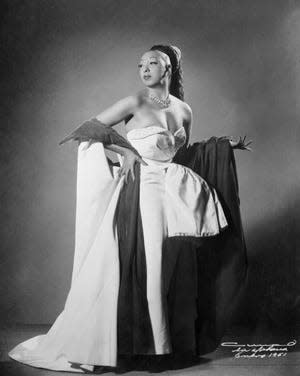 Josephine Baker, wearing one of her gorgeous gowns, part of her $150,000 collection of gowns and furs.