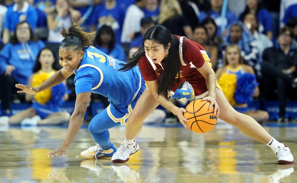 USC's Kayla Padilla, right, regains control of the ball in front of UCLA's Londynn Jones at Pauley Pavilion.