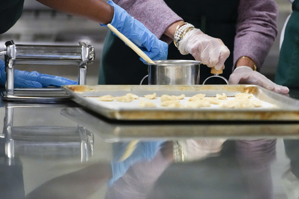 U.S. first lady Jill Biden, right, helps making ravioli in culinary class during a visit to Naples Middle High School, a Department of Defense Education Activity (DoDEA) school, after attending events on the sidelines of the G20 summit in Rome, Monday, Nov. 1, 2021. (AP Photo/Alessandra Tarantino)