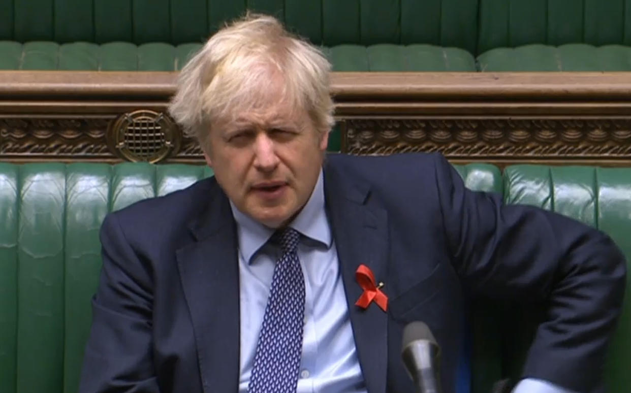 Prime Minister Boris Johnson listens as Labour leader Sir Keir Starmer speaks in the debate on the motion to approve regulations related to public health, covering the Government's coronavirus tiered system, in the House of Commons, London. (Photo by House of Commons/PA Images via Getty Images)