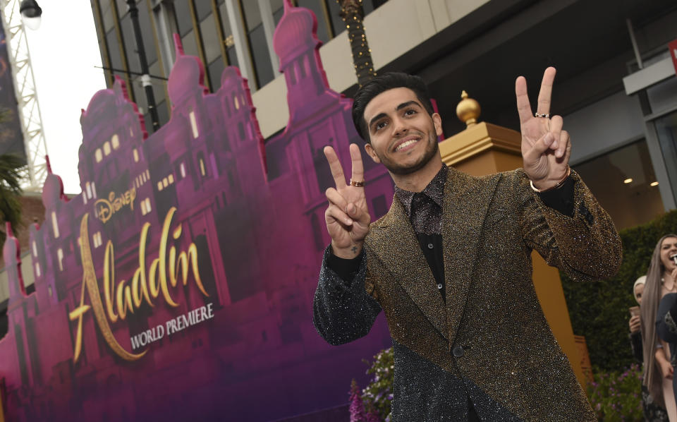 Mena Massoud arrives at the premiere of 