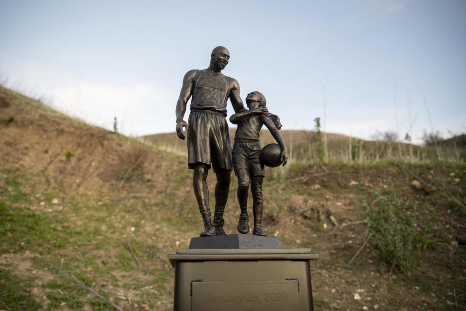 Artist Dan Medina's bronze sculpture depicting Kobe Bryant, daughter Gianna Bryant, and the names of those who died in a helicopter crash in 2020 is seen during a one-day temporary memorial display in Calabasas, California. / Credit: Josh Lefkowitz / Getty Images