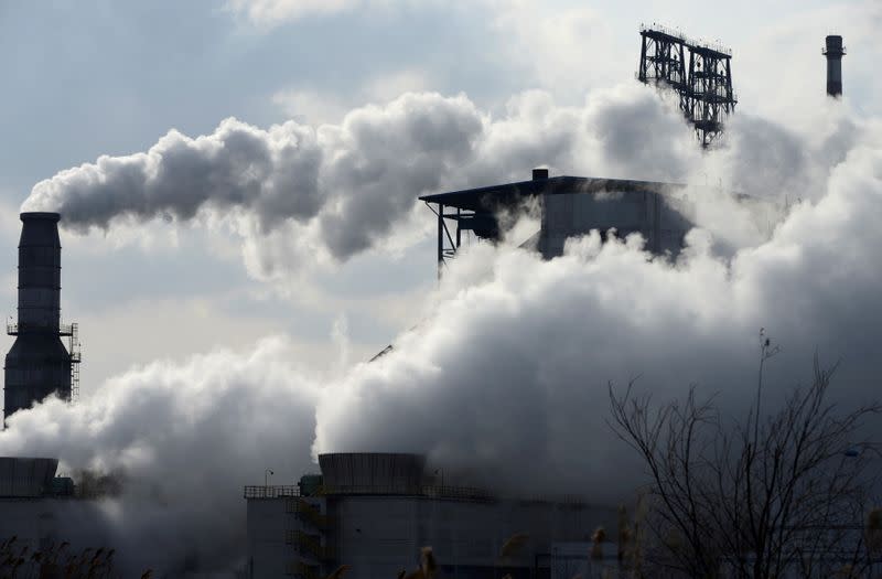 FILE PHOTO: Smoke rises from chimneys at a Sinopec refinery in Qingdao, Shangdong province