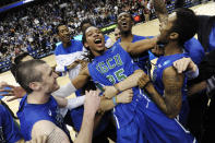 FILE - In this March 24, 2013, file photo, Florida Gulf Coast's Sherwood Brown, center, celebrates with teammates after their 81-71 win over San Diego State in a third-round game in the NCAA college basketball tournament in Philadelphia. The team's leading scorer and Atlantic Sun player of the year who received honorable mention for the AP All-America team — Sherwood Brown got seven NBA tryouts before beginning his pro career overseas. Without Dunk City, NBA teams probably wouldn't have taken notice of the player who showed up at FGSU as an unrecruited walk-on. (AP Photo/Michael Perez, File)