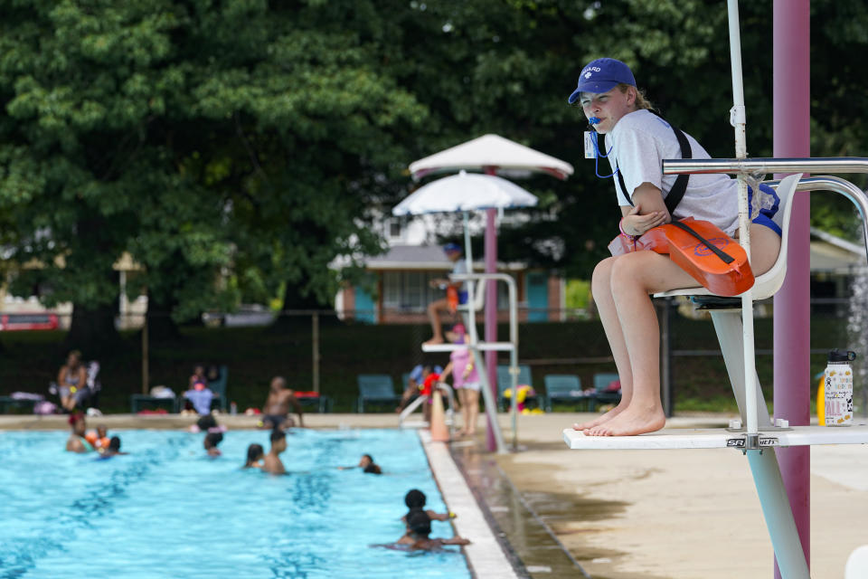 Lifeguard Elizabeth Conley keeps an eye on the swimmers at the Douglass Park pool in Indianapolis, Friday, June 17, 2022. Indianapolis typically fills 17 pools each year, but with a national lifeguard shortage exacerbated by the COVID-19 pandemic, just five are open this summer. The American Lifeguard Association estimates one-third of pools in the United States are impacted by the shortage. (AP Photo/Michael Conroy)