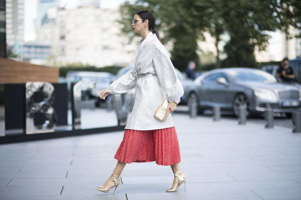 Throw on a robe coat on over a punchy pleated skirt, and belt it to create a silhouette.
