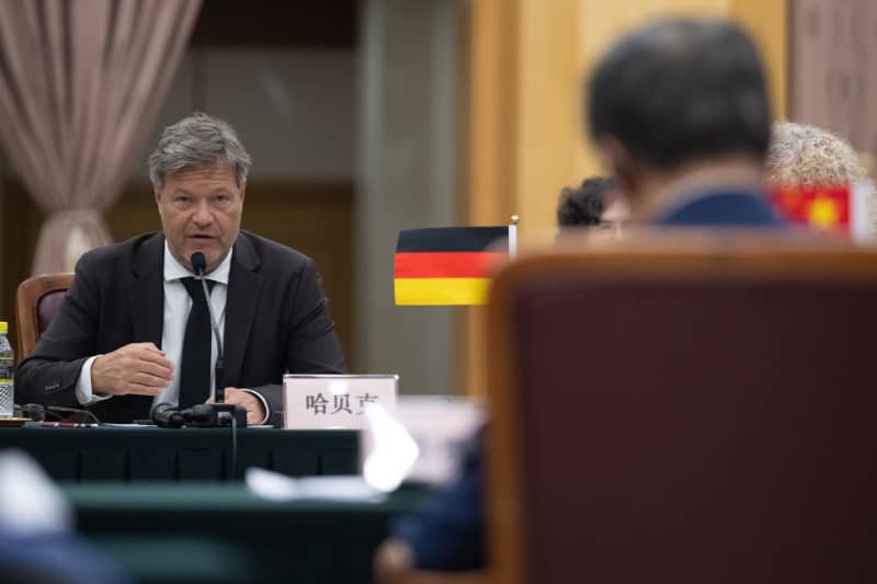 Robert Habeck (L), Germany's Minister for Economic Affairs and Climate Protection, speaks during the Sino-German Climate and Transformation Dialogue with the National Reform and Development Commission as part of a visit to the People's Republic of China. Sebastian Christoph Gollnow/dpa