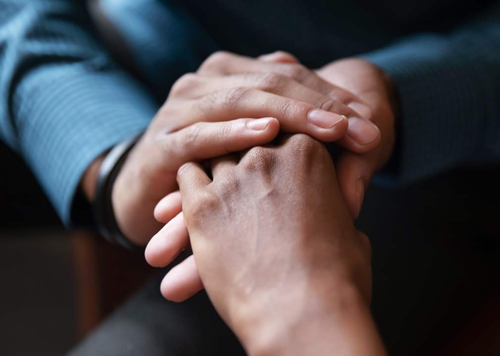 Close up of two people holding hands