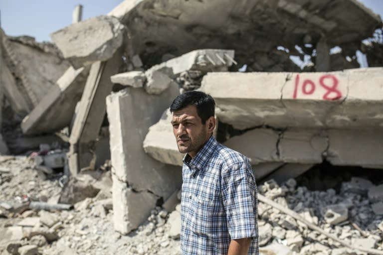 Abdullah Kurdi, father of three-year-old Aylan Kurdi, who drowned off Turkey, stands in front of his neighbour's house on September 6, 2015 in Kobane, Syria