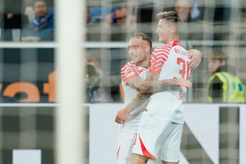 Leipzig's Benjamin Sesko (R) celebrates scoring his side's first goal with teammate David Raum during the German Bundesliga soccer match between TSG 1899 Hoffenheim and RB Leipzig at PreZero Arena. Uwe Anspach/dpa