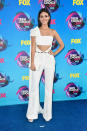 <p>Showing off her arms and tummy, the <i>Victorious</i> star styled her white jumpsuit with a simple white clutch. And let’s not ignore that cape! </p>