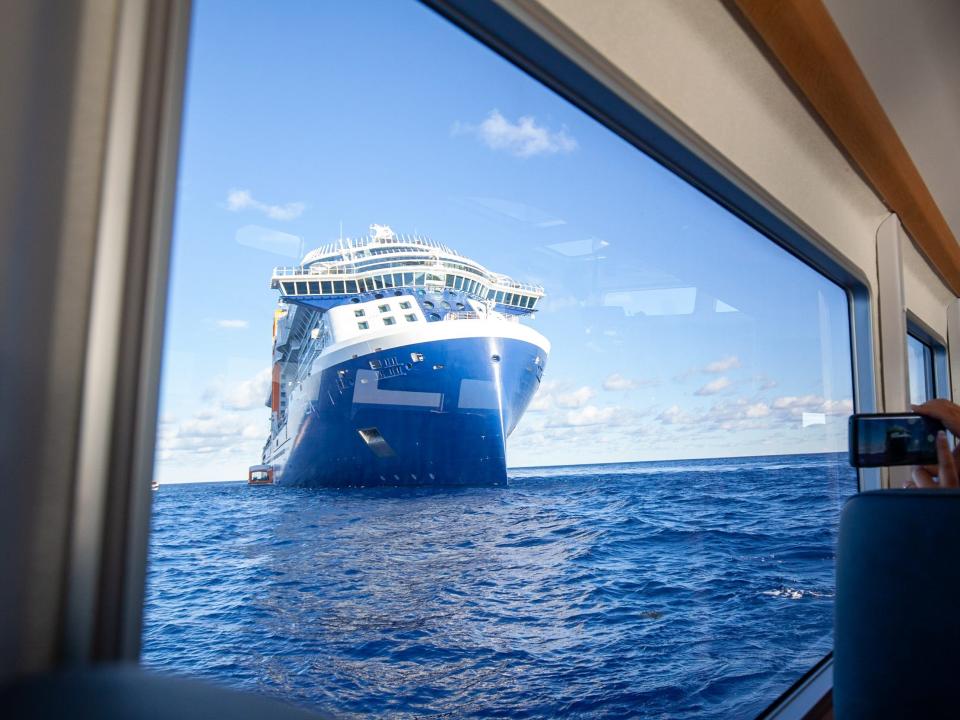 the Celebrity Apex cruise ship at sea as photographed through the window of a tender