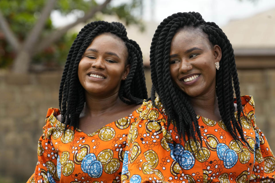 Twins Kehinde Adamolekun, left, and Taiwo Adamolekun, 28, attend the annual twins festival in Igbo-Ora South west Nigeria, Saturday, Oct. 8, 2022. The town holds the annual festival to celebrate the high number of twins and multiple births. (AP Photo/Sunday Alamba)