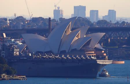 The USS Bonhomme Richard amphibious assault ship manoeuvres into port in front of the Sydney Opera House in Australia, June 29, 2017 after a ceremony on board the ship marking the start of Talisman Saber 2017, a biennial joint military exercise between the United States and Australia. REUTERS/David Gray