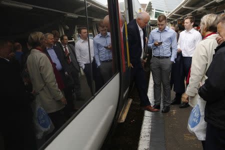 FILE PHOTO: Passengers alight and board a Southern railway train at Clapham Junction rail station in south London, in Britain, September 2, 2016. REUTERS/Luke MacGregor