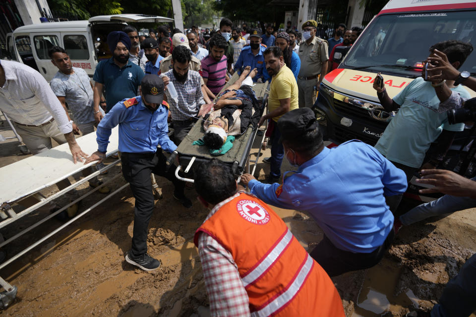 A passenger injured in a bus accident in Jammu and Kashmir's Poonch district is brought for treatment at a hospital in Jammu, India, Wednesday, Sept.14, 2022. Nearly a dozen people died and more people were injured when a mini-bus plunged into a deep gorge Wednesday. (AP Photo/Channi Anand)