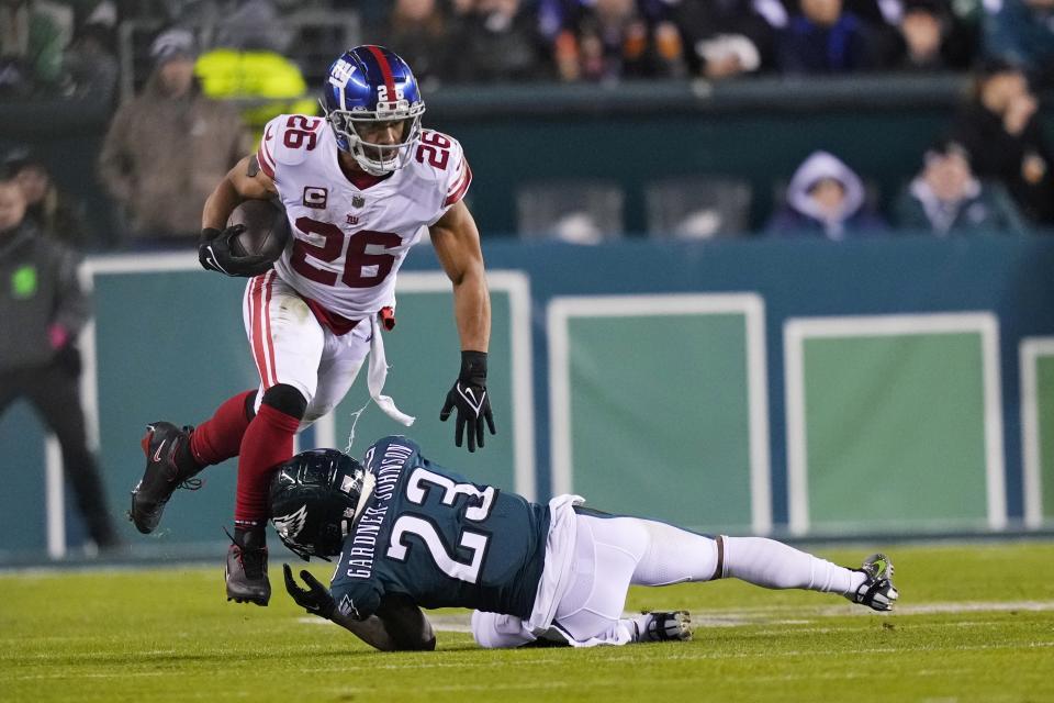 New York Giants running back Saquon Barkley (26) runs with the ball as Philadelphia Eagles safety C.J. Gardner-Johnson (23) tries to stop him during the second half of an NFL divisional round playoff football game, Saturday, Jan. 21, 2023, in Philadelphia. (AP Photo/Matt Slocum)