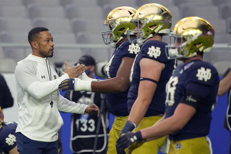 Notre Dame head coach Marcus Freeman greets players prior to the Fiesta Bowl NCAA college football game against Oklahoma State, Saturday, Jan. 1, 2022, in Glendale, Ariz. (AP Photo/Rick Scuteri)