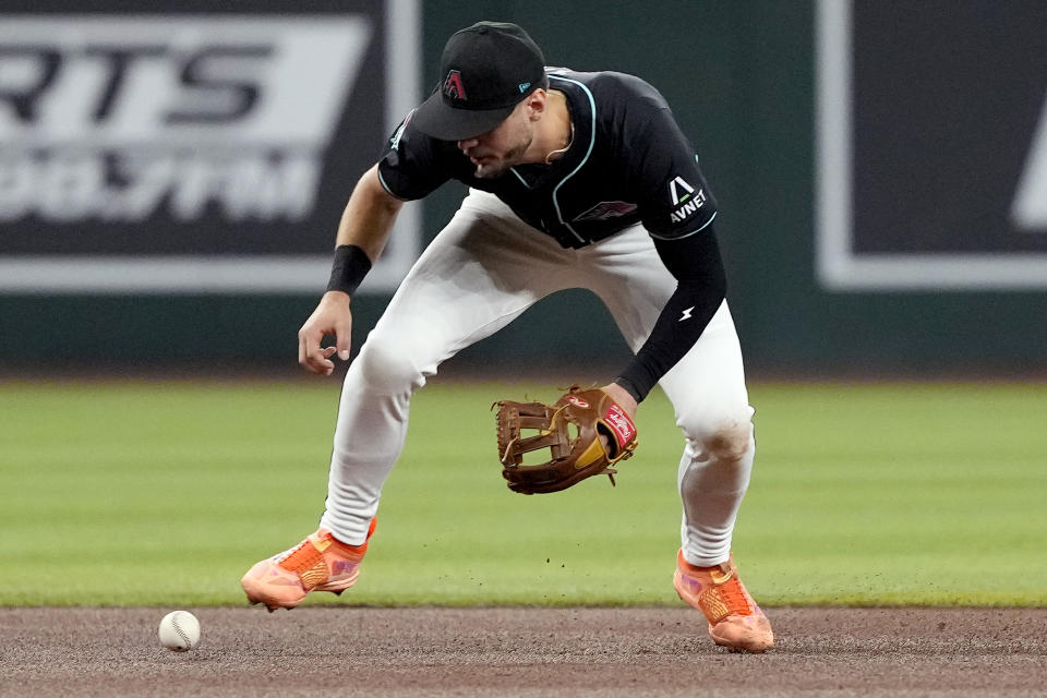 Arizona Diamondbacks' Blaze Alexander bobbles the ball hit by San Diego Padres' Xander Bogaerts for an error during the fourth inning of a baseball game, Saturday, May 4, 2024, in Phoenix. (AP Photo/Matt York)