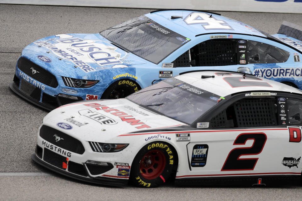 Kevin Harvick (4) and Brad Keselowski (2) compete during the NASCAR Cup Series auto race Sunday, May 17, 2020, in Darlington, S.C. (AP Photo/Brynn Anderson)