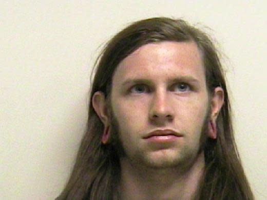 In this photo provided by the Utah County Sheriff's Department showing Kai Christensen, 21, of Provo, who was booked Saturday into the county jail for investigation of misdemeanor reckless endangerment. A Forest Service law enforcement officer with military experience discovered trip wires for the booby traps at entrances of a crude shelter made of dead tree limbs in Provo Canyon, said Utah County sheriff's Sgt. Spencer Cannon. (AP Photo/Utah County Sheriff Department)