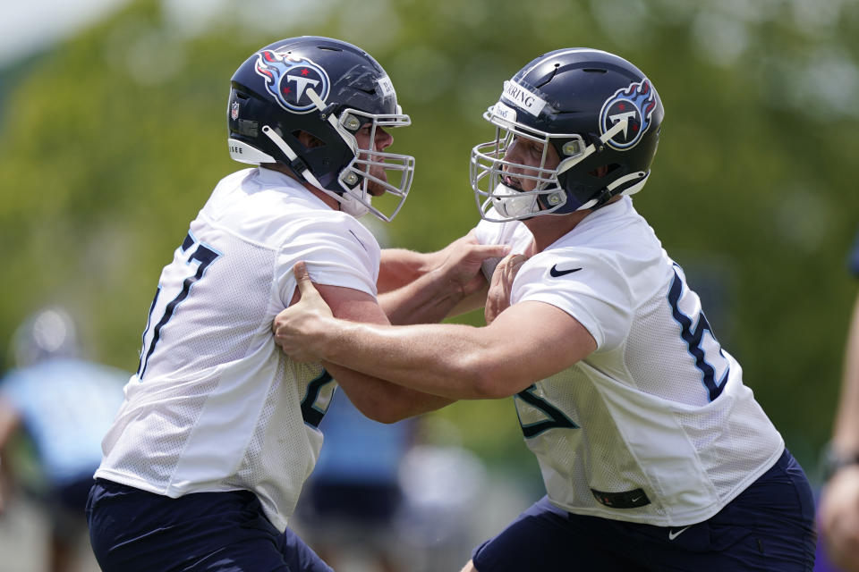 Tennessee Titans guard Cole Banwart, left, and defensive tackle Chandon Herring, right, run a drill during NFL football rookie minicamp Saturday, May 15, 2021, in Nashville, Tenn. (AP Photo/Mark Humphrey, Pool)