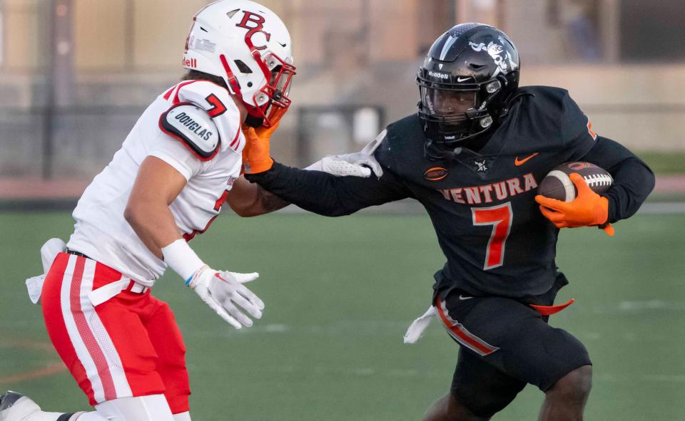 Ventura College running back Lamonte James stiff-arms Bakersfield College's Julian Smith during the Pirates' win Saturday night at the VC Sportsplex.