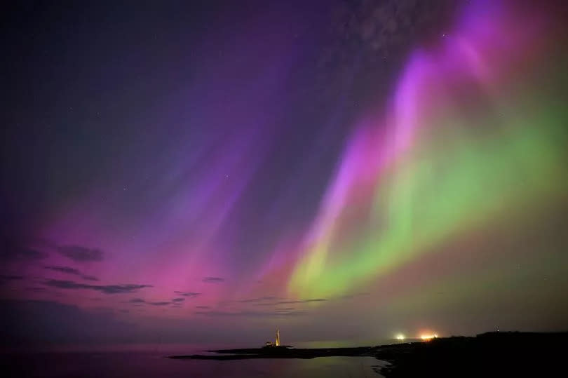 The aurora borealis, also known as the northern lights, glow in the sky over St Mary's Lighthouse in Whitley Bay