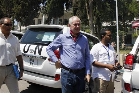 Ake Sellstrom (C), the head of a U.N. chemical weapons investigation team, stands outside Yousef al-Azma military hospital in Damascus August 30, 2013. REUTERS/Khaled al-Hariri