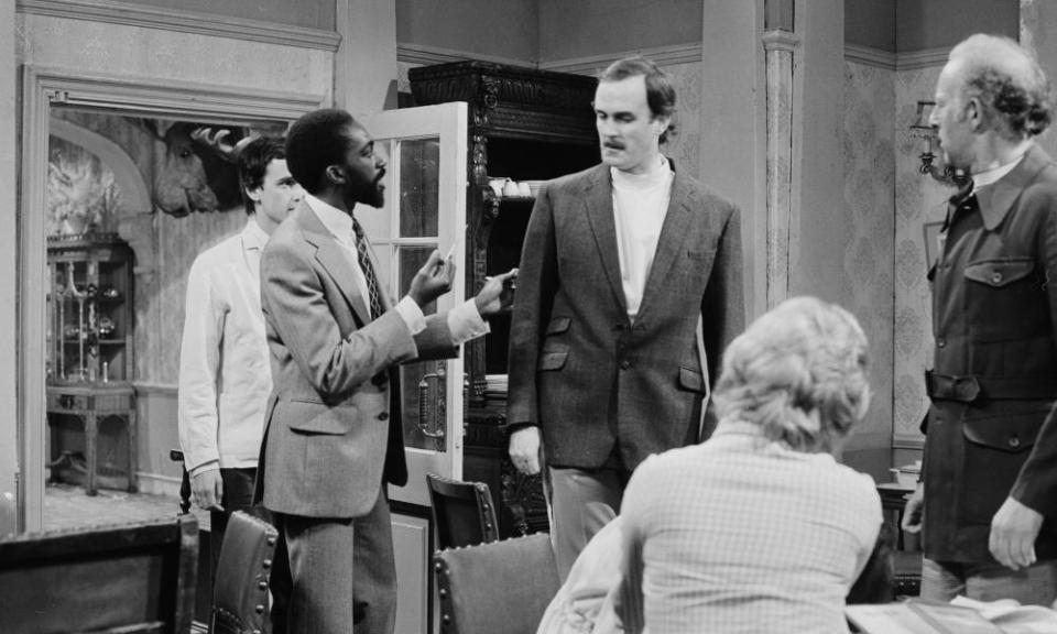 Louis Mahoney, second from left, with John Cleese, centre, in The Germans, an episode of the BBC sitcom Fawlty Towers, 1975.