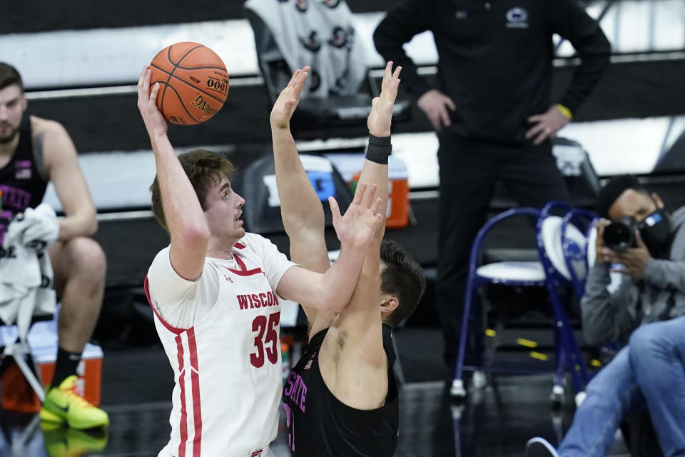 Wisconsin's Nate Reuvers (35) shoots over Penn State's John Harrar (21) during the first half of an NCAA college basketball game at the Big Ten Conference tournament, Thursday, March 11, 2021, in Indianapolis. (AP Photo/Darron Cummings)