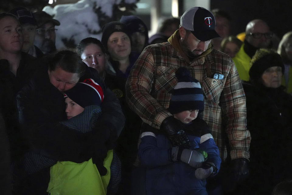 People attend a candlelight vigil after two police officers and a first responder were shot and killed Sunday, Feb. 18, 2024, in Burnsville, Minn. (AP Photo/Abbie Parr)